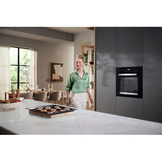 Miele Built In Electric Single Oven - Black - Oven in kitchen with women walking shot