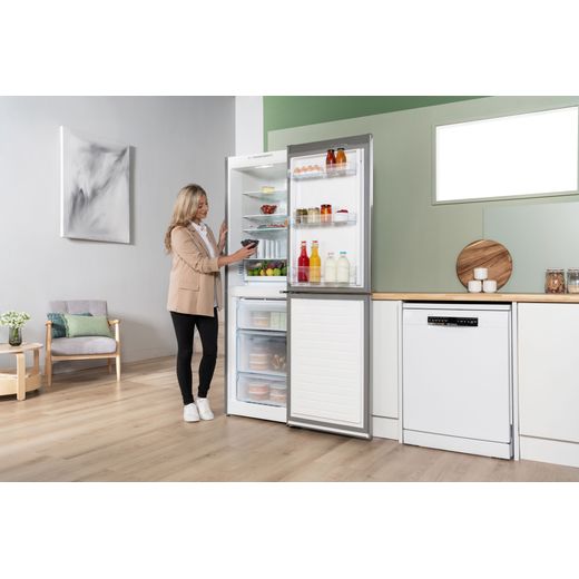 Bosch Series 2 50/50 Total No Frost Fridge Freezer - Stainless Steel Effect - Women putting food in fridge shot