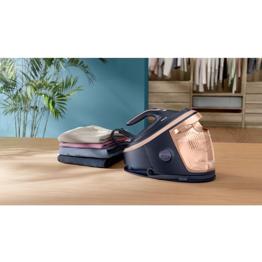 Philips 7000 Series Steam Generator Iron - Blue - Iron next to folded clothes pile
