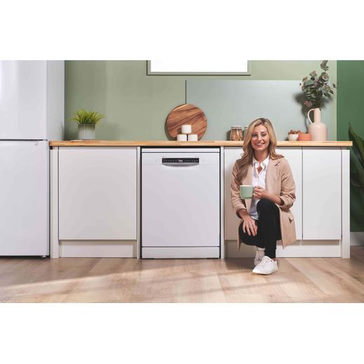 Bosch Series 4 Standard Dishwasher - White - Woman sat next to dishwasher