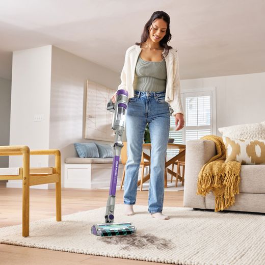 Shark PowerDetect IP1251UKT Cordless Vacuum Cleaner with up to 70 Minutes Run Time - White / Java Grey - Woman cleaning rug