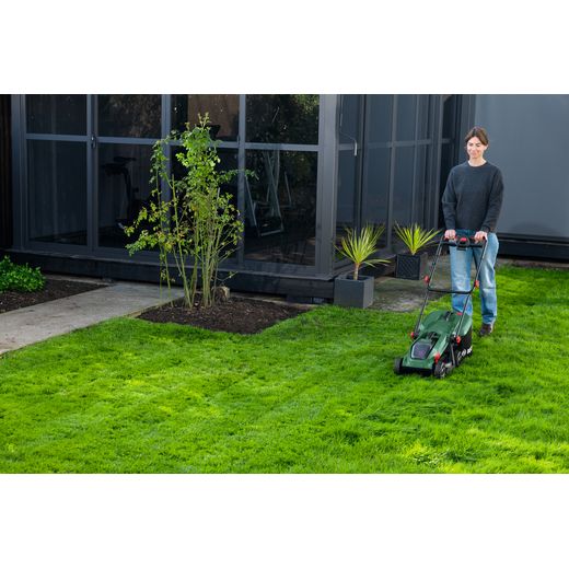 Bosch 06008B9P70 Lawn Mower, Including Battery - Person mowing lawn
