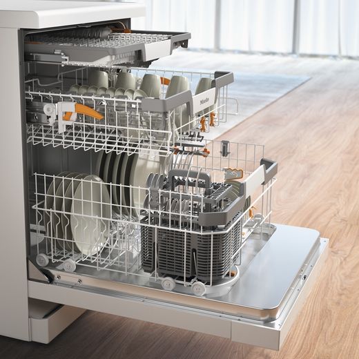 Miele Standard Dishwasher - White - Door open and racks out in kitchen