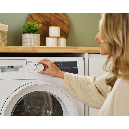 Bosch Series 4 WTH85225GB 8Kg Heat Pump Tumble Dryer - White - Women changing setting shot