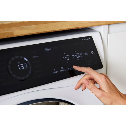 Bosch Series 8 i-Dos 10.5Kg / 6Kg Washer Dryer - White - Person turning on machine shot