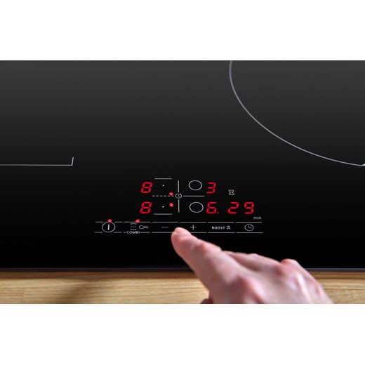 Bosch Series 4 PWP611BB5B 59cm Induction Hob - Black - person using control panel shot