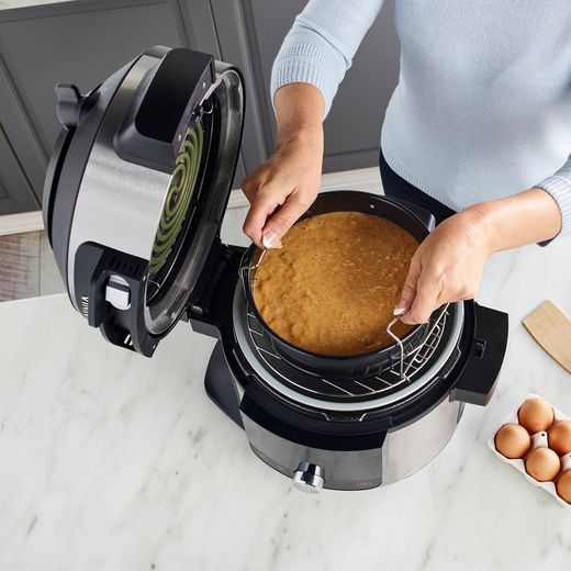 Ninja Foodi Max 15-in-1 SmartLid 7.5 Litre Multi Cooker - Stainless Steel / Black - Women in modern kitchen preparing a meal