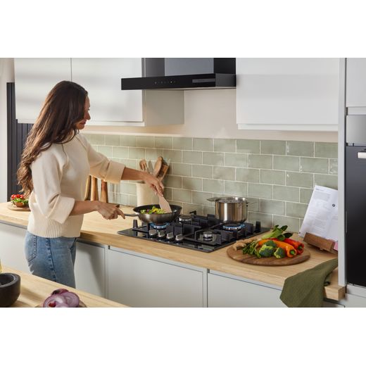 Bosch Series 4 PNP6B6K40 59cm Gas Hob - Black - women cooking in kitchens shot