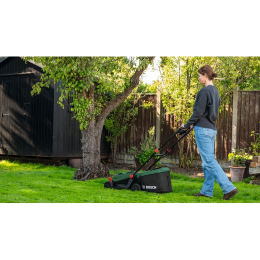 Bosch 06008B9P70 Lawn Mower, Including Battery - Person mowing lawn
