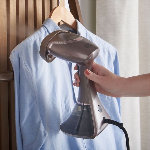 Russell Hobbs Steam Genie Aroma 28040 Handheld Garment Steamer - Grey - Person steaming shirt shot