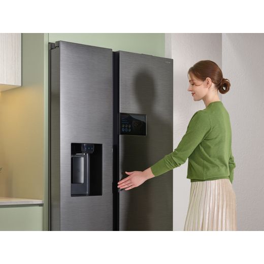 Samsung Series 9 AI Home American Fridge Freezer - Silver - Woman touching fridge freezer