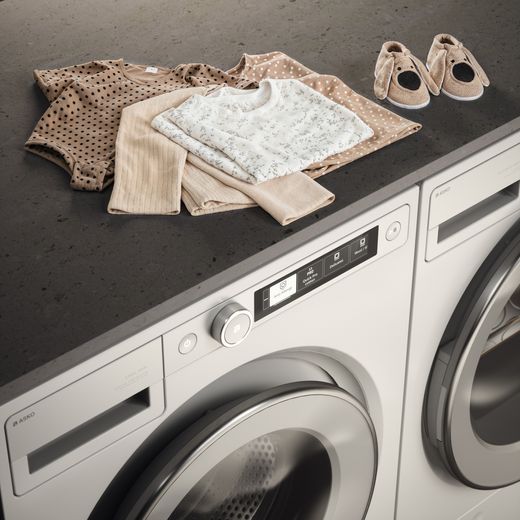 ASKO W5096RW.UK 9kg Washing Machine with 1600 rpm - White - Clothes on worktop above washing machine