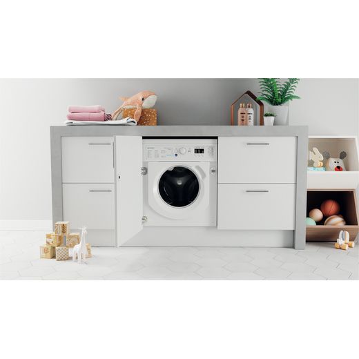 Indesit Integrated 7Kg / 5Kg Washer Dryer - White - Washer dryer in cupboard in utility room shot